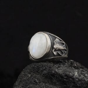 elephant ring is a statement ring with elephant ornaments and a white moon stone gemstone on top of it