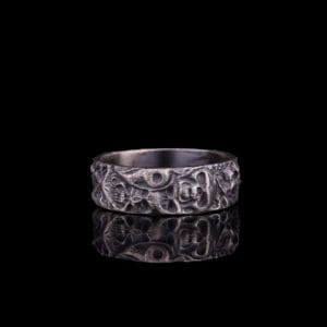 spirit ring is a sterling silver band jewelry that has skull ornamentation.