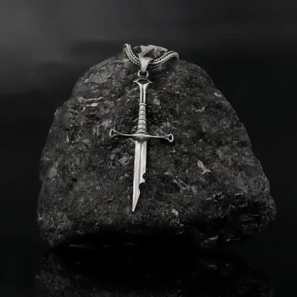broken sword displayed on a black rock.