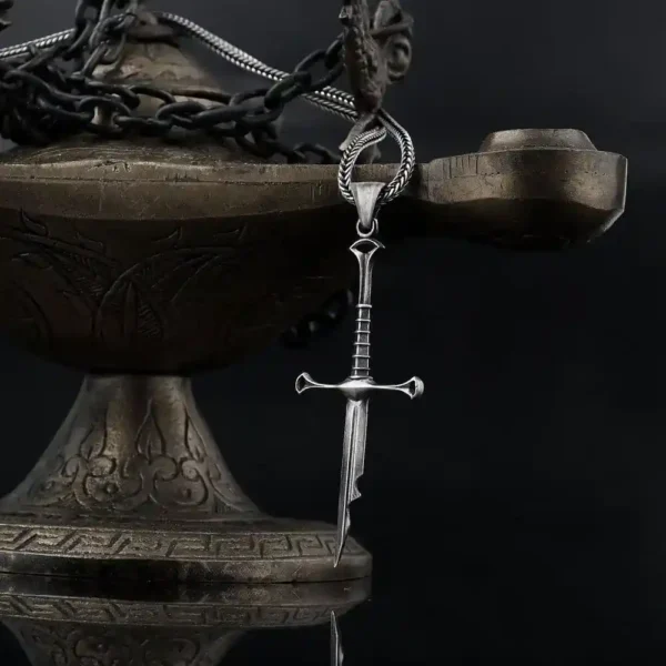 the image contains shards of narsil. this product is inspired by lotr universe. the narsil necklace is displayed on oil lamp.